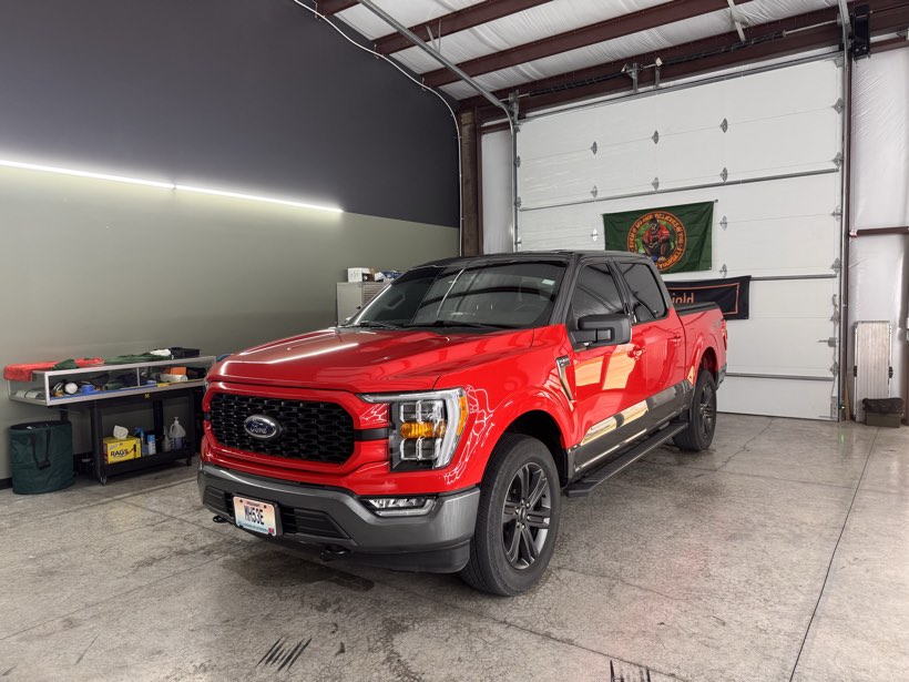 Red Ford F-150 with window tint, fully detailed in The Auto Film Studio install bay