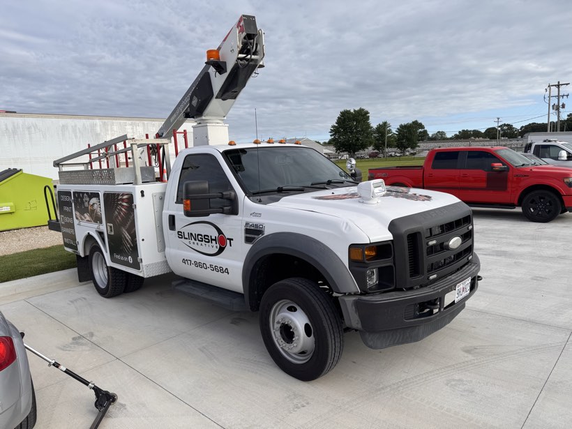 White Ford F-450 bucket truck with commercial window tint from The Auto Film Studio