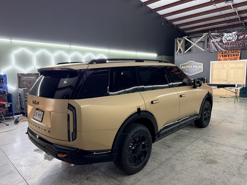 Kia Telluride with a vinyl accent wrap on the rear quarter panel, under hexagon LED lighting at The Auto Film Studio