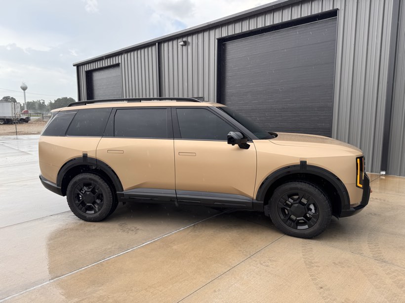 Matte sand Kia Telluride with finished window tint parked outside the Rogersville shop