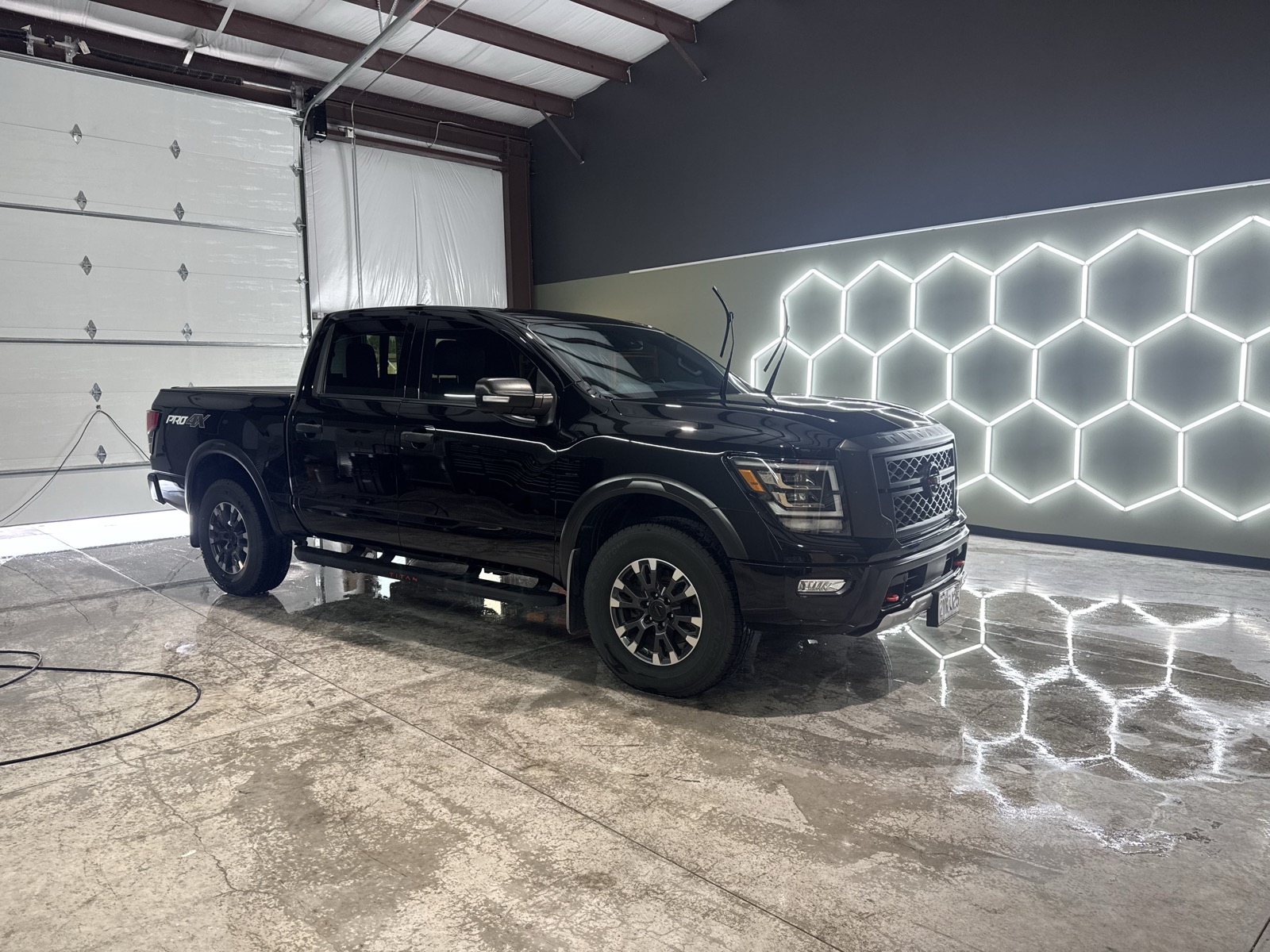 Freshly tinted black Nissan Titan in The Auto Film Studio install bay