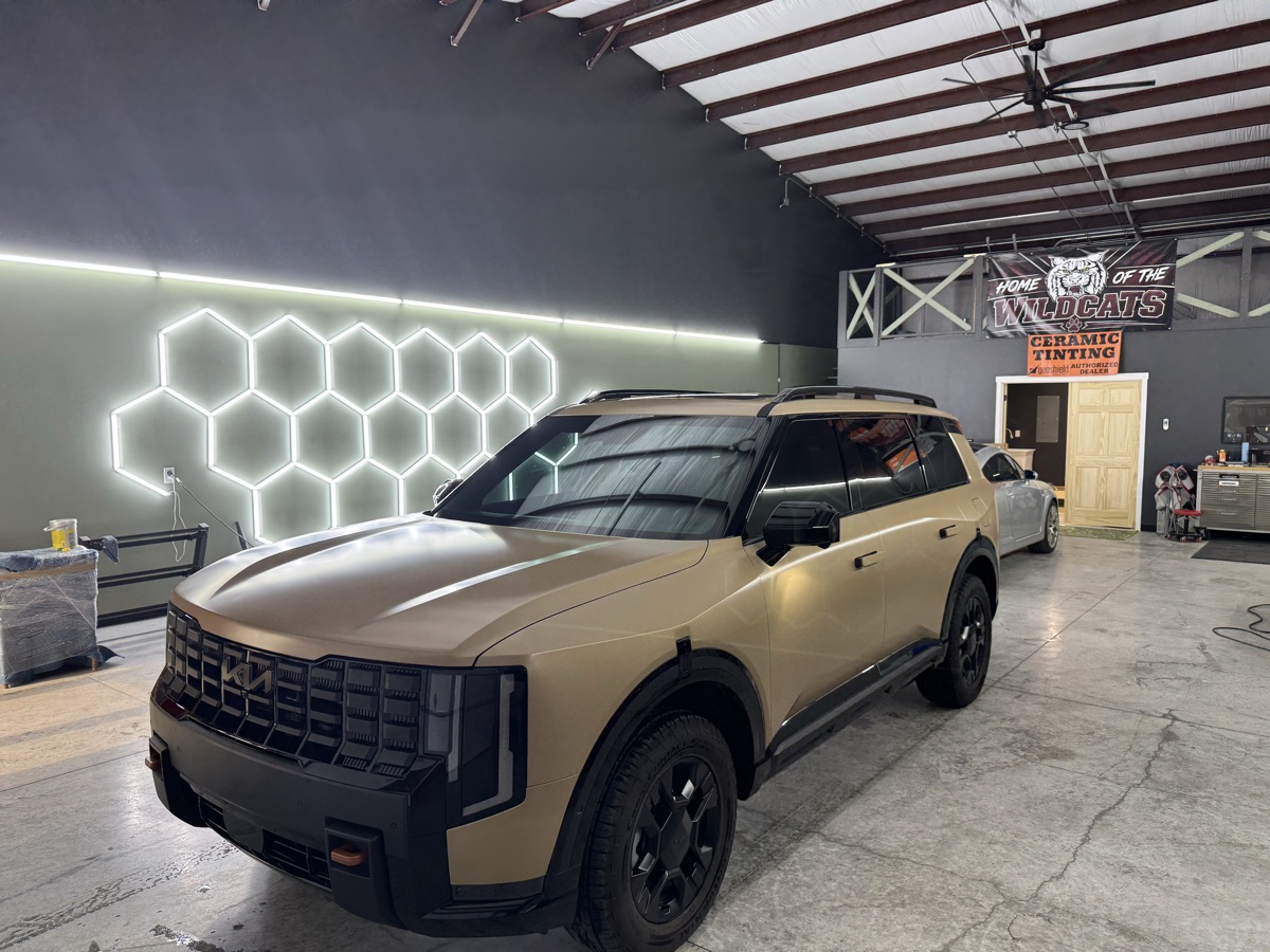 Tan matte wrapped Kia Telluride, front three-quarter view